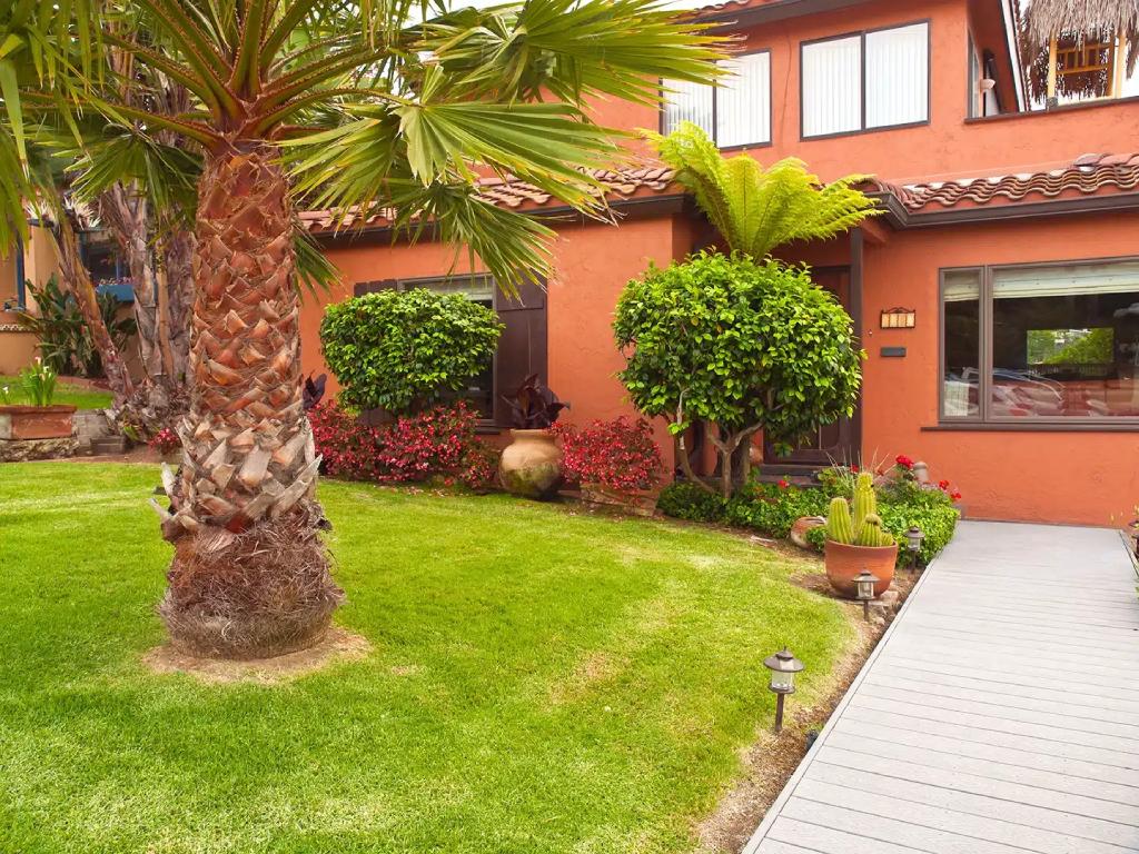 California Spanish Bungalow with Terracotta Stucco Lush Succulent Garden and Palm Trees.jpg