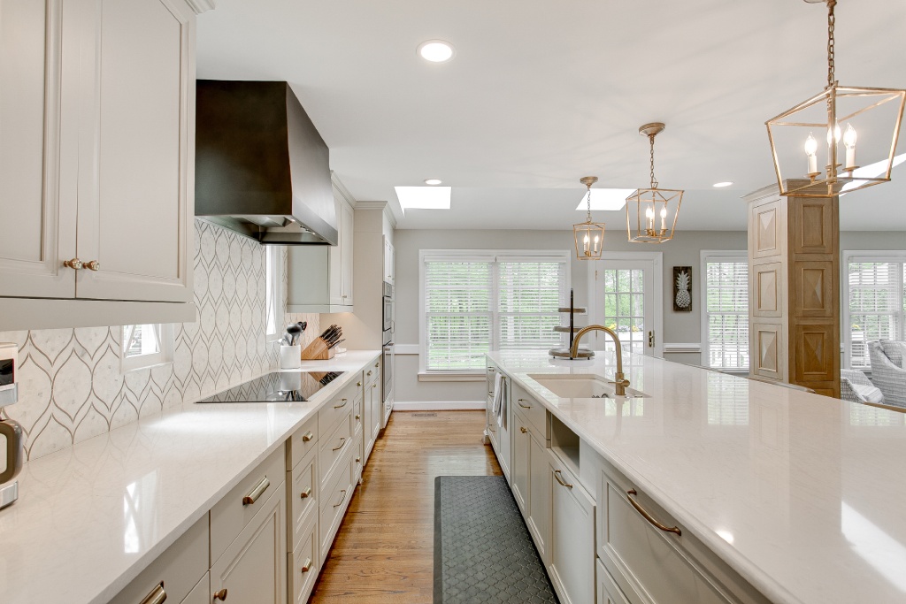 Luxury Transitional Kitchen with White Quartz Island Black Range Hood and Gold Lantern Pendant Lights.jpg