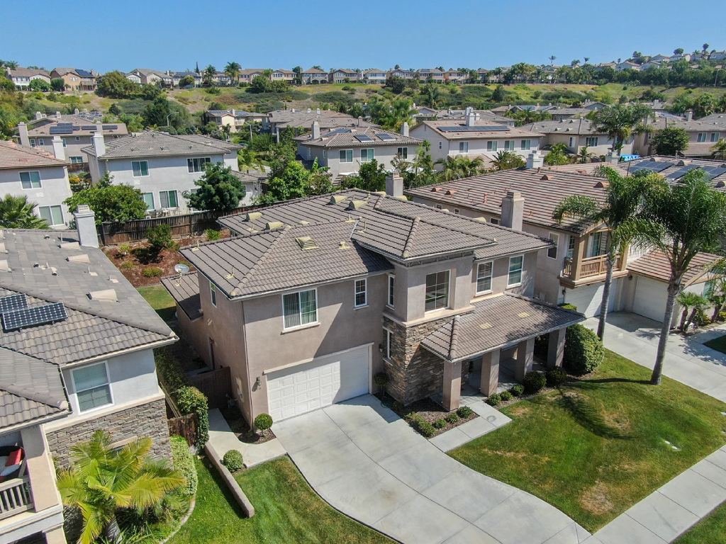 Modern San Diego Suburban Estate with Spanish Tile Roof Stone Accents and Solar Panels.jpg