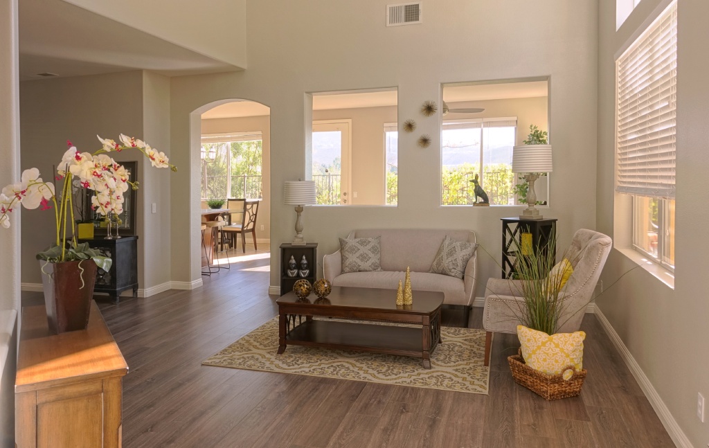 Modern Traditional Living Room with Beige Sofa Accent Chair and Dark Wood Flooring.jpg