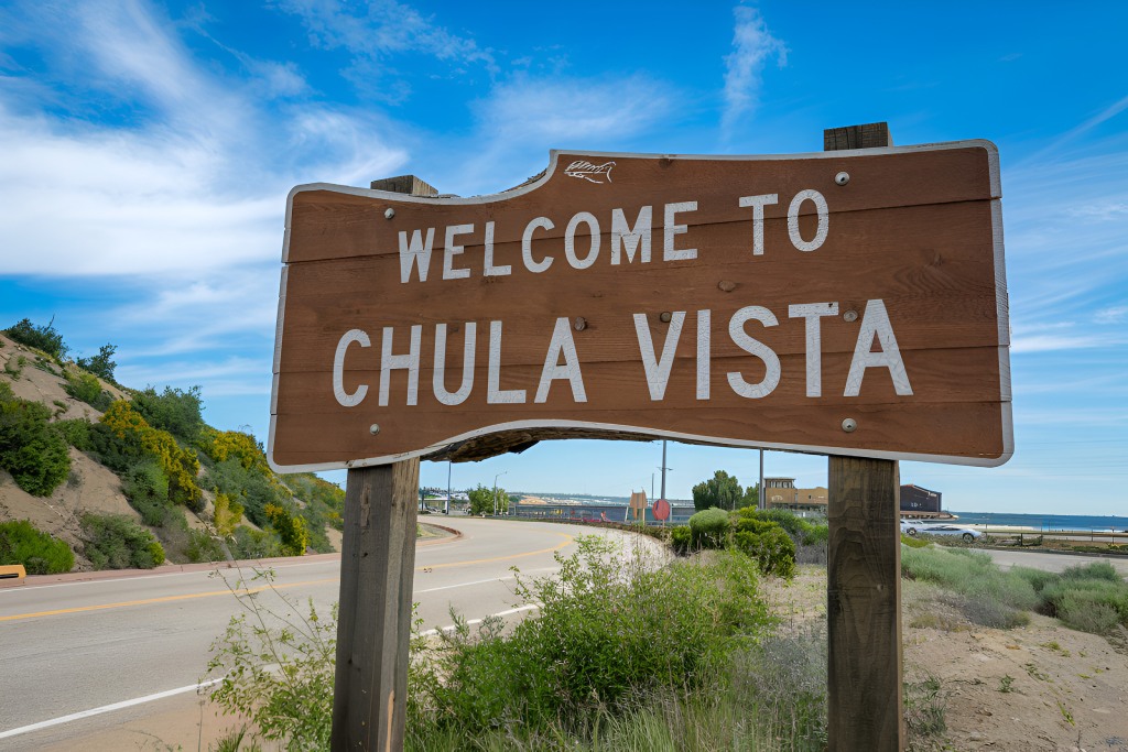 Welcome to Chula Vista Wooden City Limit Sign with Roadway and Blue Sky Background.jpg